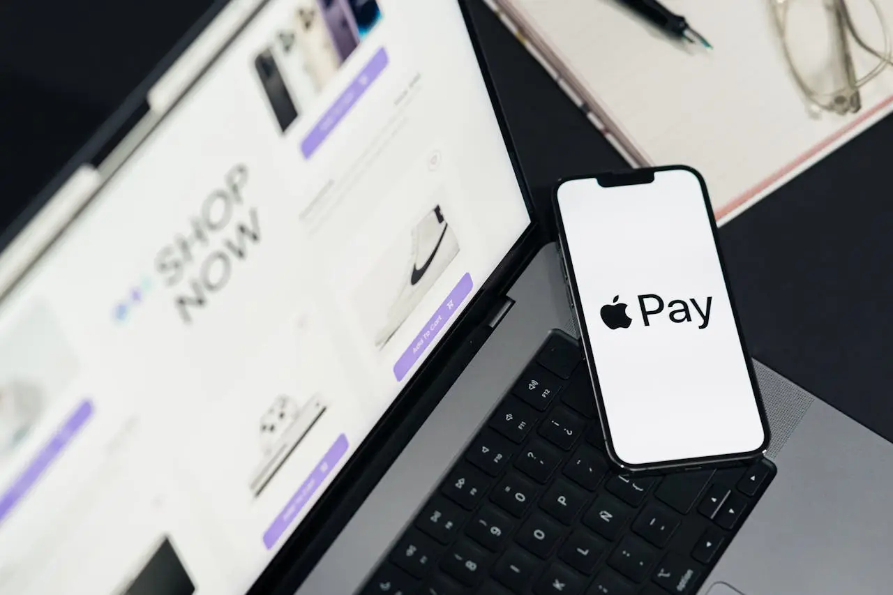 Laptop and smartphone display facilitating online shopping using mobile payment technology.
